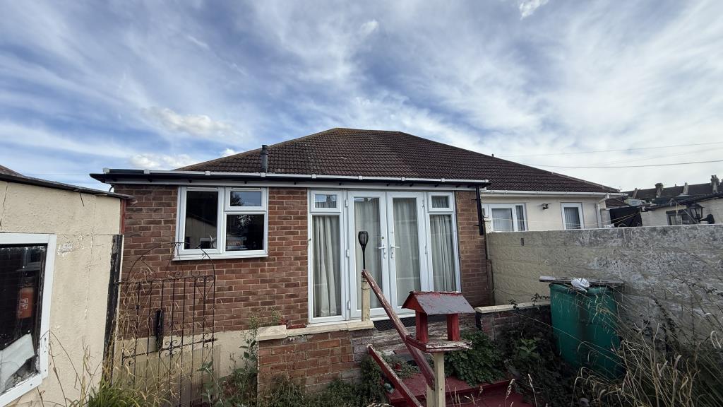 Lot: 140 - SEMI-DETACHED BUNGALOW FOR REFURBISHMENT - External image of rear of bungalow